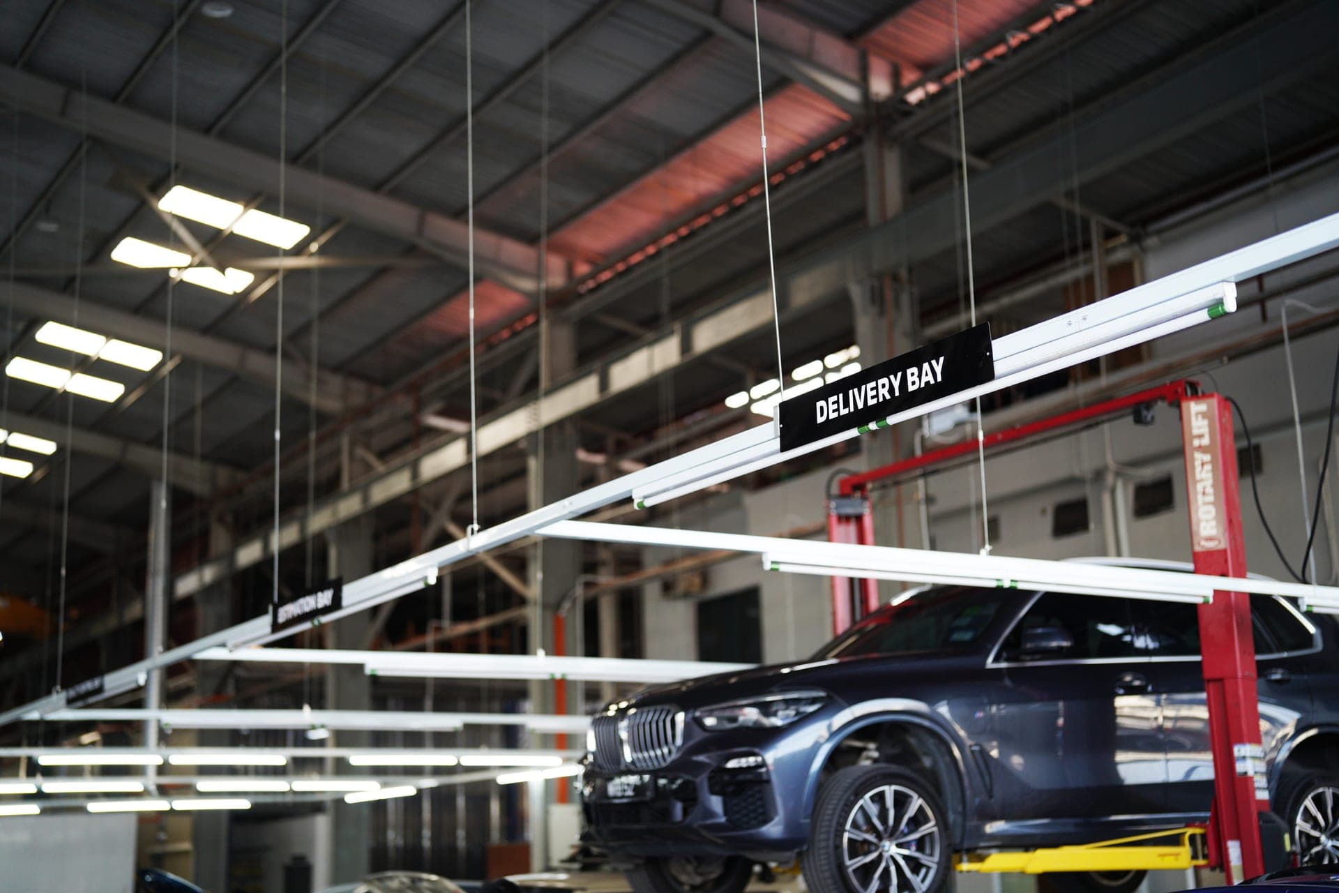 Delivery bay signage — BMW X7 on lift